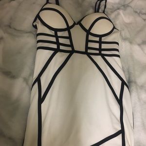White body-con dress with black detailing.